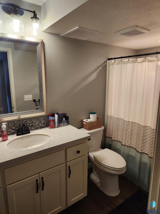 bathroom with backsplash, vanity, hardwood / wood-style floors, a shower with shower curtain, and toilet