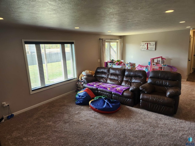 carpeted living room featuring a textured ceiling