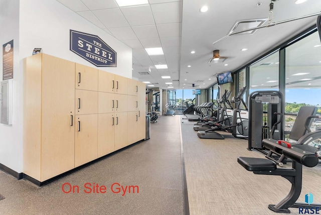 gym featuring recessed lighting, a ceiling fan, and a wall of windows