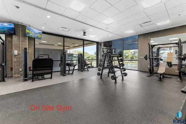 exercise room with a paneled ceiling