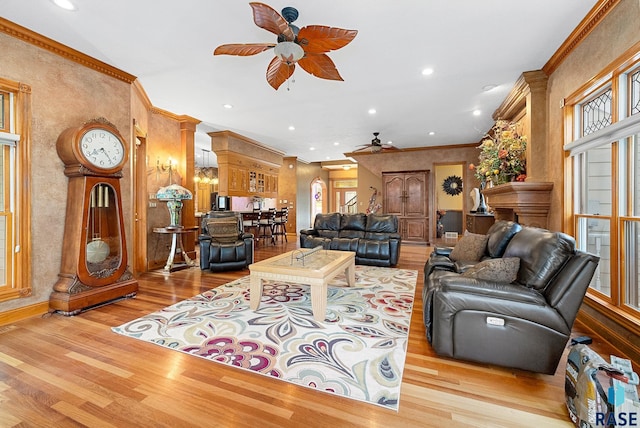 living room with light hardwood / wood-style flooring, ceiling fan, and ornamental molding