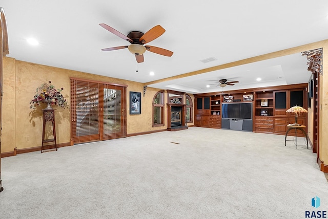 unfurnished living room with ceiling fan and carpet floors