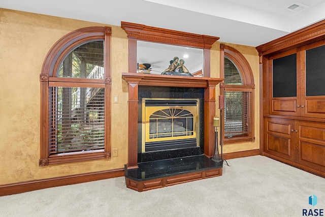 interior details featuring ceiling fan and carpet flooring