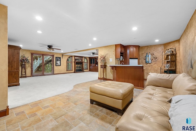 carpeted living room featuring ceiling fan