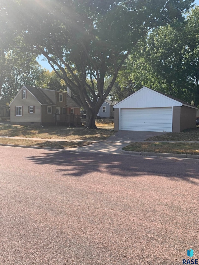 view of front facade with a garage and an outbuilding