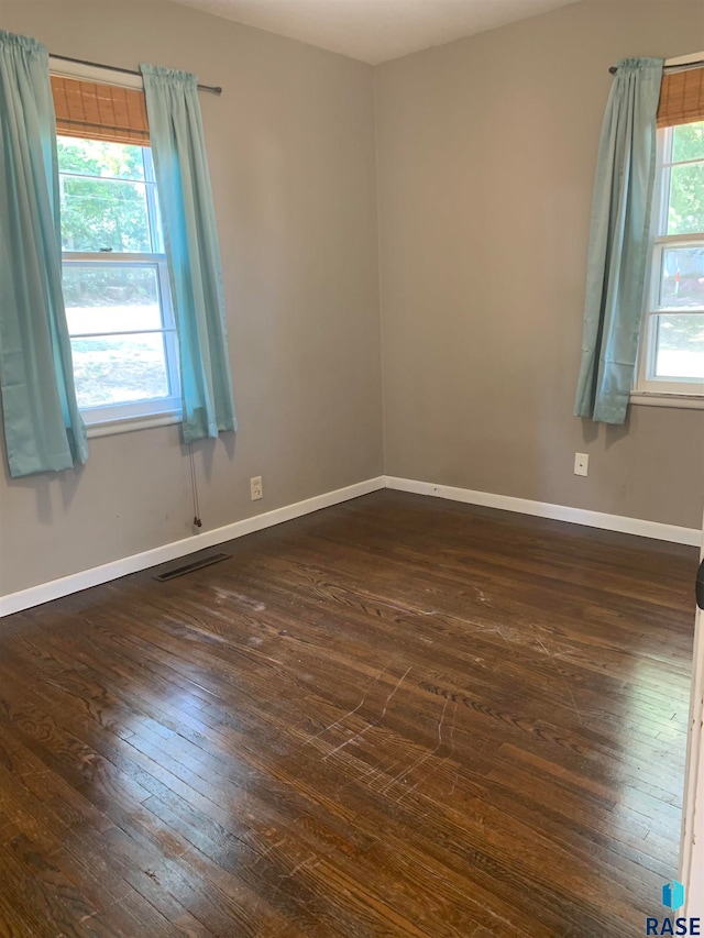 spare room with dark wood-type flooring