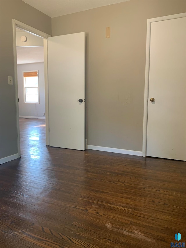 unfurnished room with dark hardwood / wood-style floors