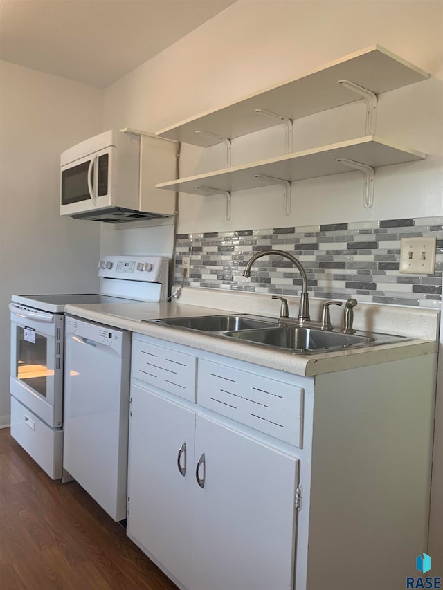 kitchen with backsplash, dark hardwood / wood-style flooring, white appliances, and white cabinetry