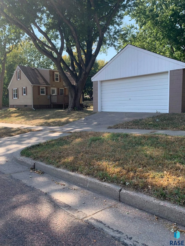 exterior space featuring a garage and an outbuilding