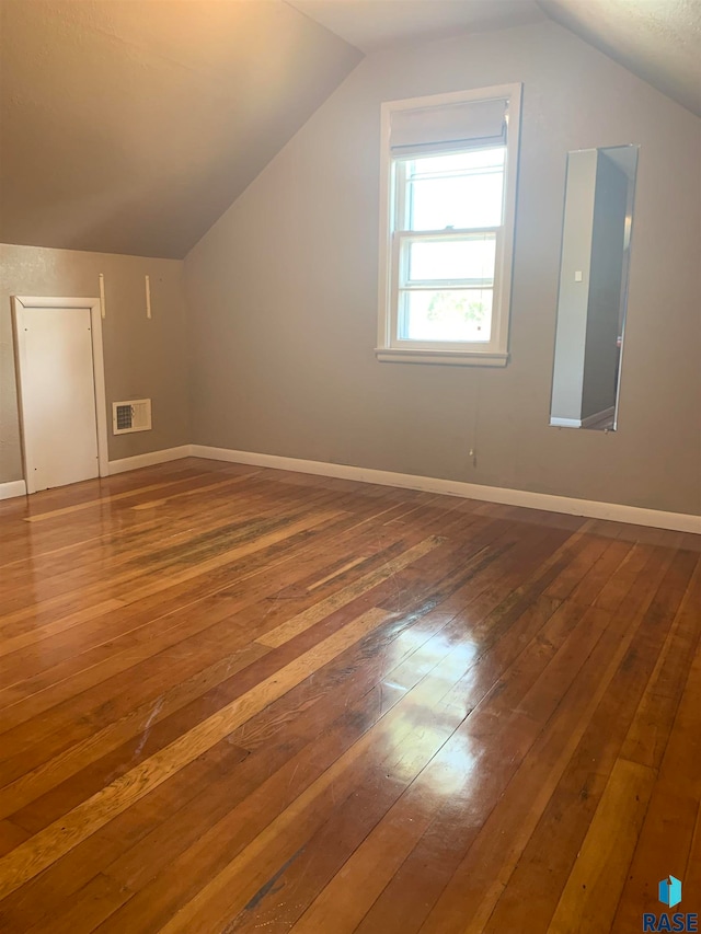 bonus room featuring lofted ceiling and hardwood / wood-style flooring