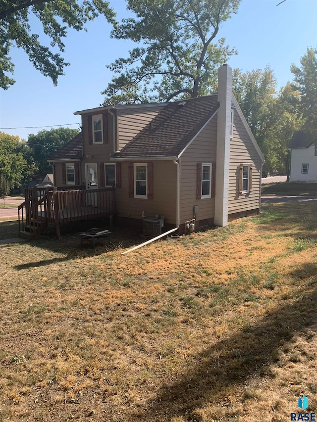 back of house featuring central air condition unit, a yard, and a deck