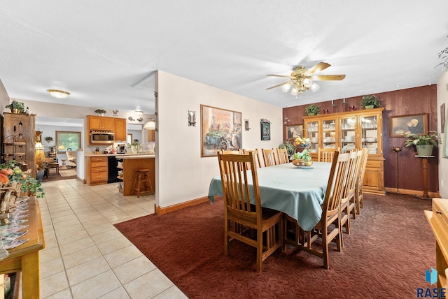 dining area featuring ceiling fan, light tile patterned floors, and a textured ceiling