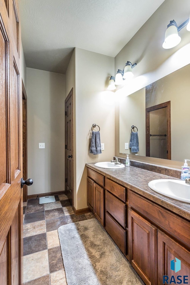 bathroom with vanity and a textured ceiling