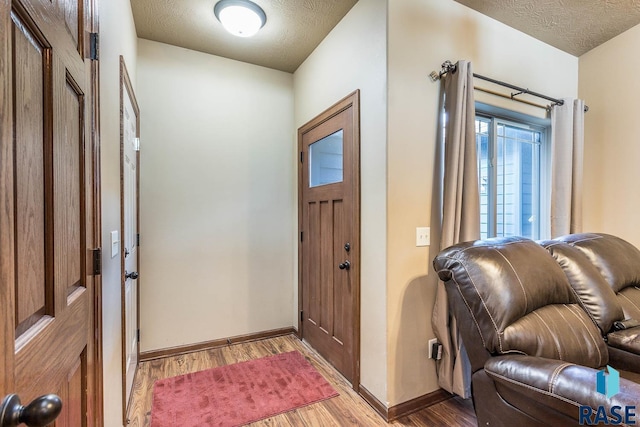 entrance foyer featuring hardwood / wood-style floors and a textured ceiling