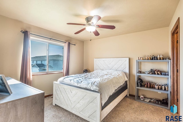 bedroom featuring light carpet and ceiling fan