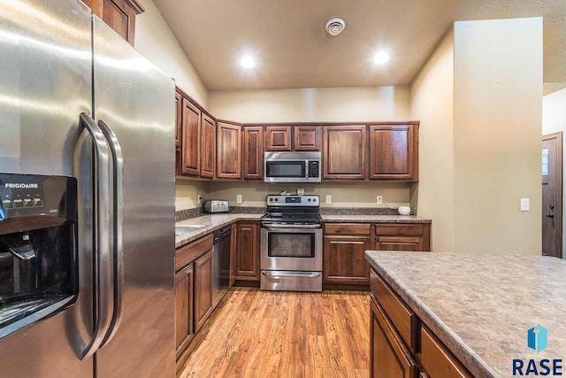 kitchen featuring stainless steel appliances and light wood-type flooring