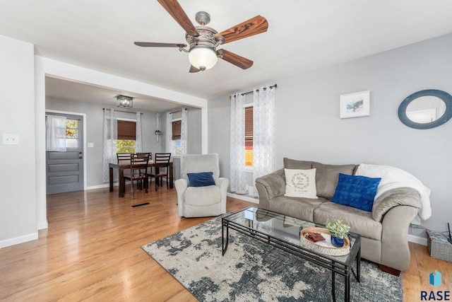 living room with hardwood / wood-style flooring and ceiling fan