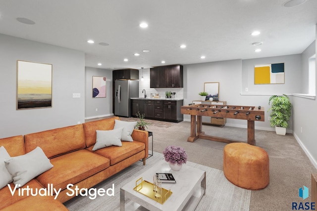 carpeted living room with sink