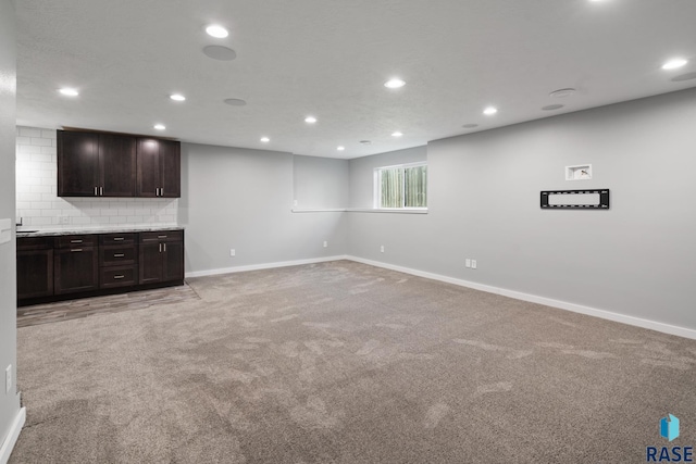 unfurnished living room featuring light carpet