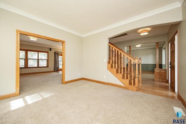 unfurnished room with crown molding and carpet