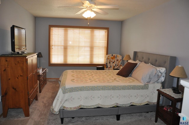 bedroom with ceiling fan and light colored carpet