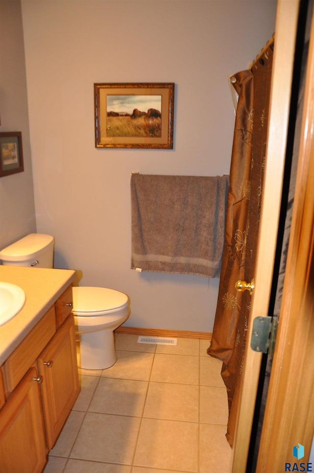 bathroom featuring tile patterned floors, vanity, and toilet