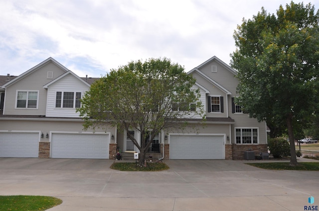 view of front of home featuring a garage and central AC unit