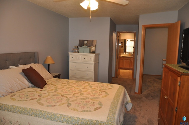 carpeted bedroom with ensuite bathroom and ceiling fan