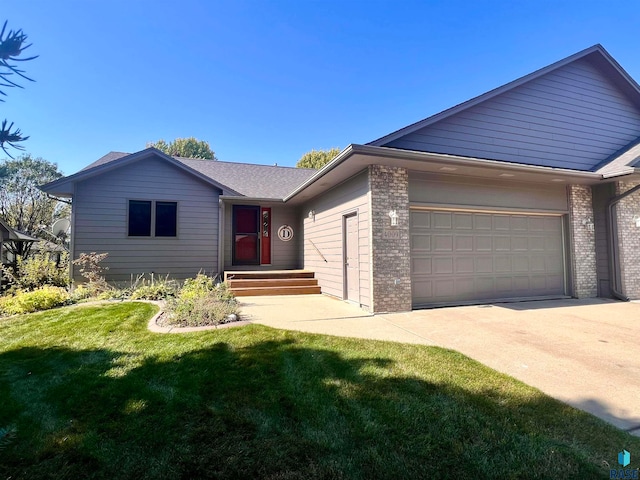 single story home featuring a garage and a front yard