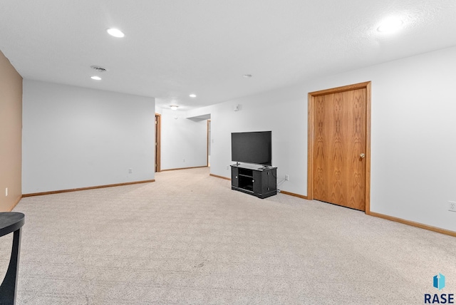 unfurnished living room with light colored carpet