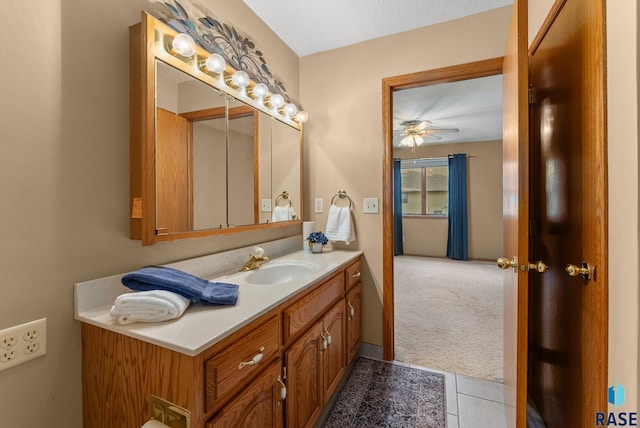 bathroom with a textured ceiling, tile patterned flooring, vanity, and ceiling fan