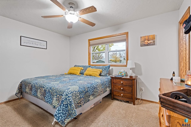 bedroom with carpet flooring, ceiling fan, and a textured ceiling