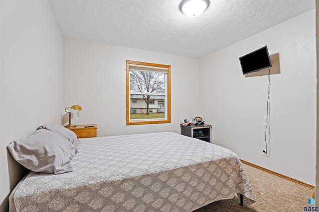 carpeted bedroom featuring a textured ceiling