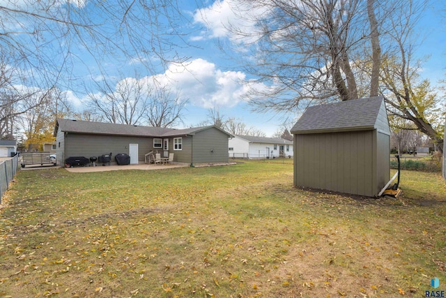 back of house with a yard, a shed, and a patio area