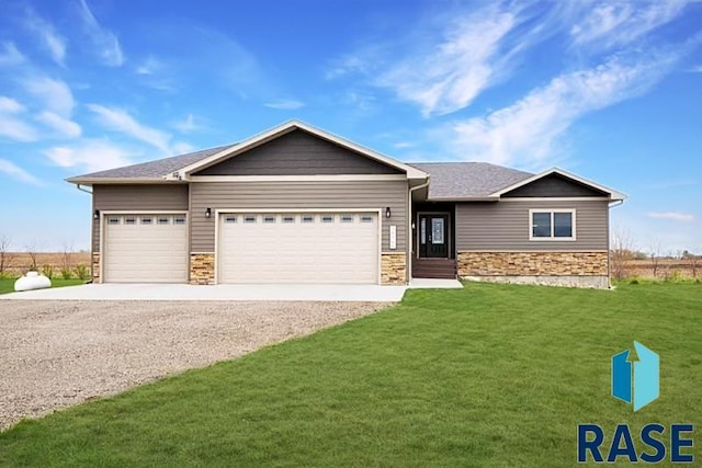 view of front of home with a front lawn and a garage