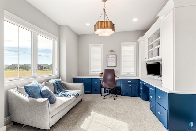 carpeted home office featuring built in desk