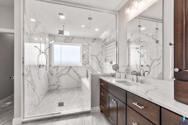 bathroom featuring vanity and a shower with shower door