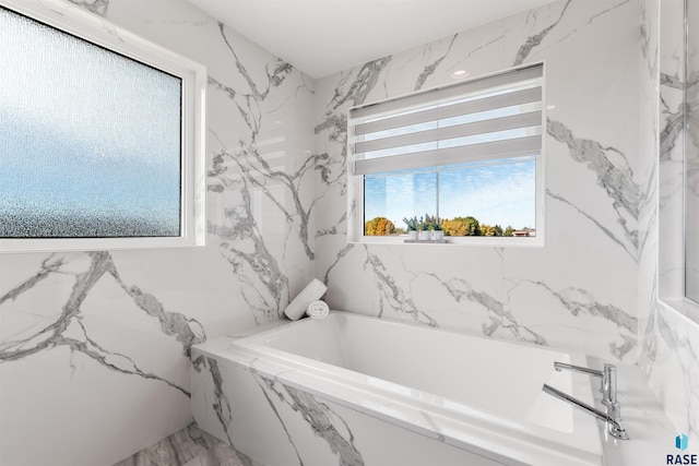 bathroom with a relaxing tiled tub