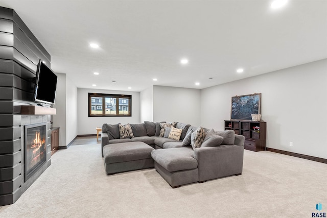 carpeted living room with a large fireplace