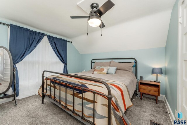 carpeted bedroom with vaulted ceiling and ceiling fan