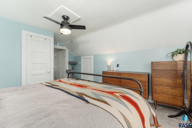 bedroom featuring vaulted ceiling, light colored carpet, and ceiling fan