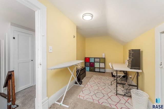 office area with lofted ceiling and carpet flooring