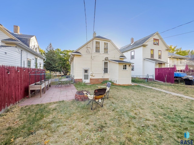 rear view of property with a patio and a lawn