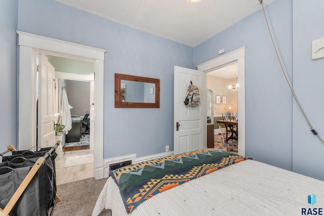 carpeted bedroom with a notable chandelier