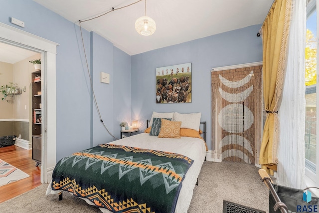 bedroom with hardwood / wood-style floors