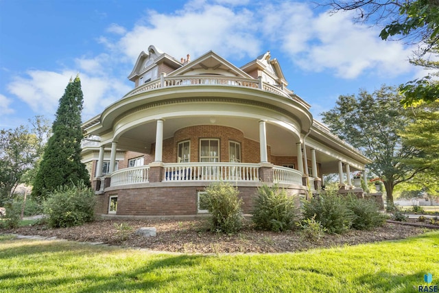 victorian home featuring a porch and a front yard