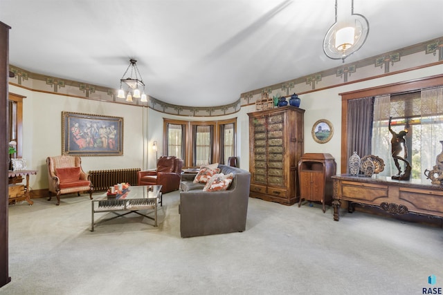 carpeted living room with an inviting chandelier and radiator