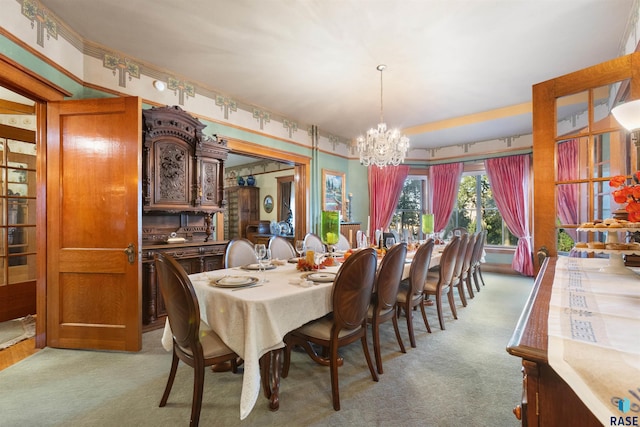 dining room with a notable chandelier and light colored carpet