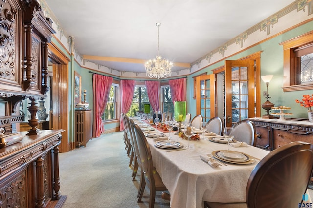 dining room with a notable chandelier and light colored carpet