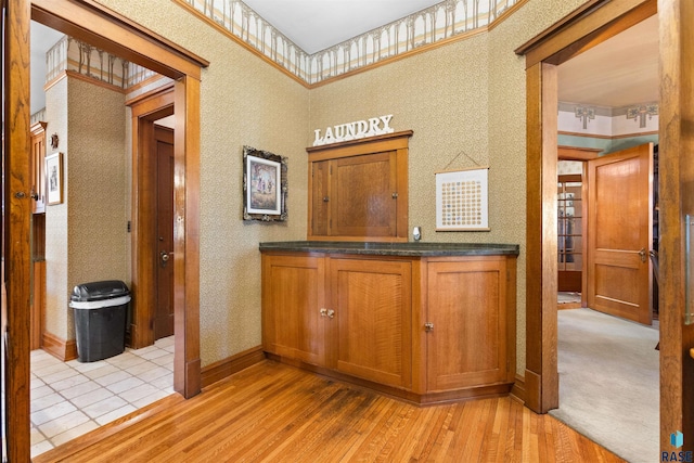 interior space featuring a towering ceiling and light hardwood / wood-style floors